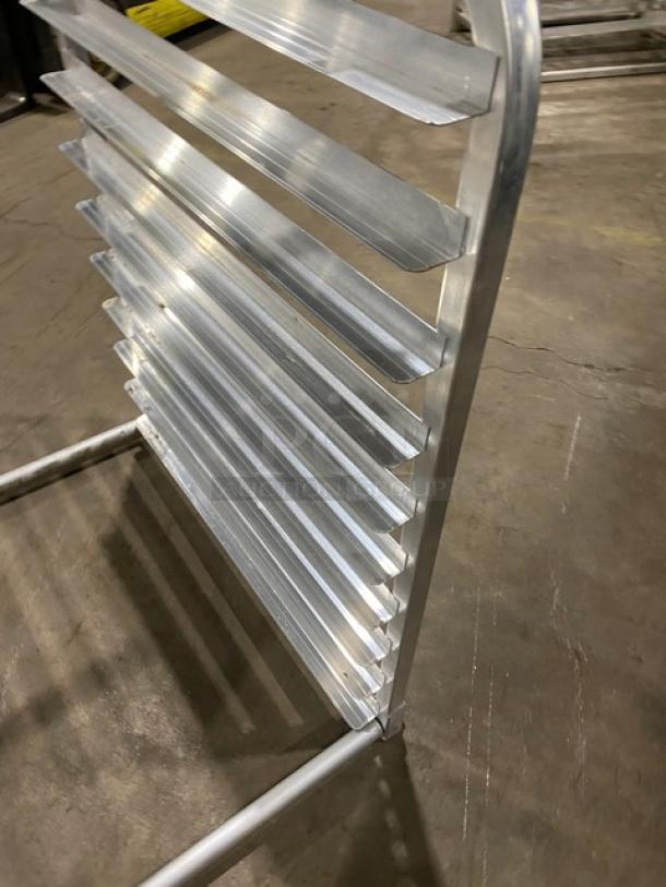 Stainless steel commercial pan holding rack with multiple slots, heavy-duty design, excellent condition. Ideal for kitchens.