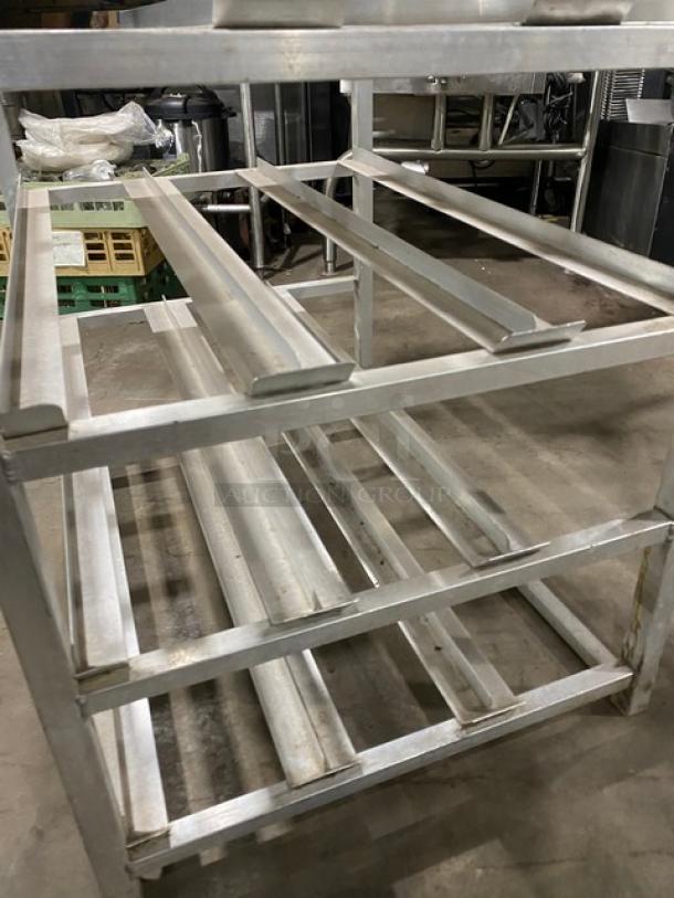 Channel commercial heavy-duty pan holding/cooling rack on legs, in used condition. Features multiple slots for pans.