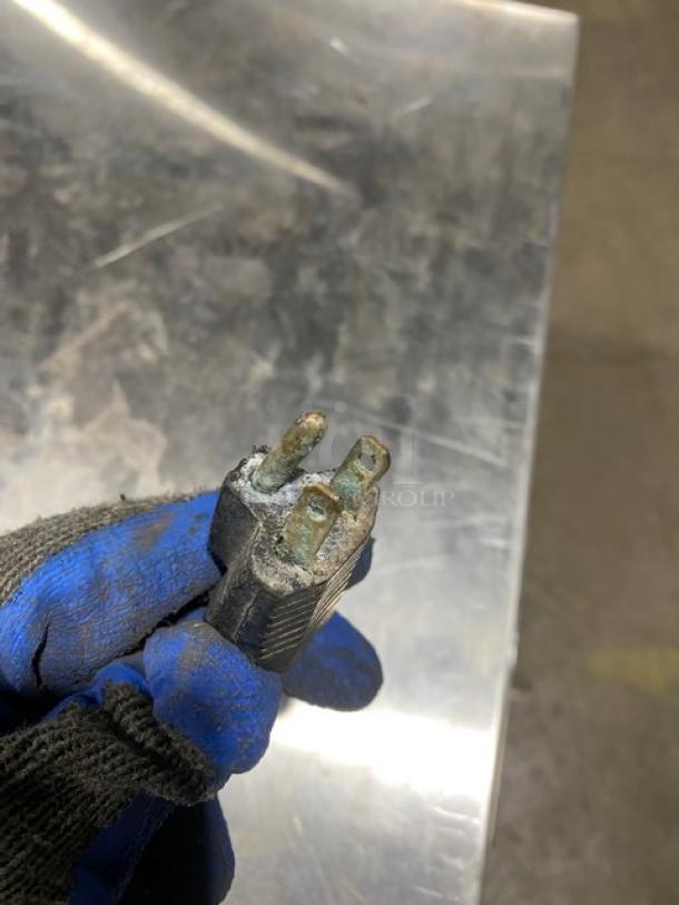Close-up of a worn electrical plug with corrosion, part of the Eagle Group RedHots Series warming drawer, 120V, 1 Phase.