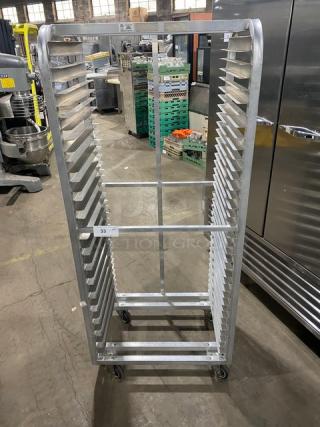 Commercial heavy-duty pan holding/cooling rack on casters, metal construction, vertical slots, used condition, marked "33".