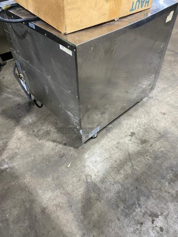Moffat Turbofan commercial stainless steel countertop convection oven, electric-powered, with pan holding slides, on legs.