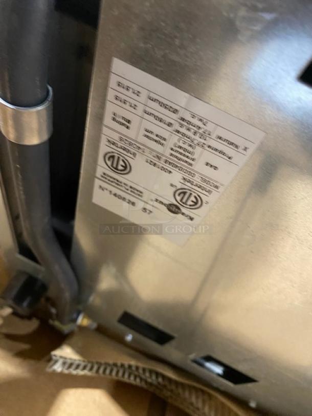 Krampouz stainless steel natural gas crepe maker, new. Manufacturer tag visible, detailing specifications and certifications.