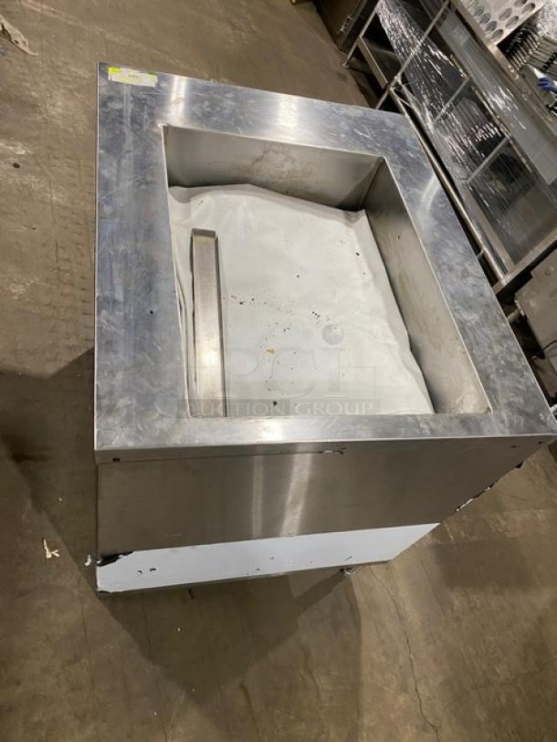 Commercial stainless steel single-well hot food/steam table with enclosed double undershelf base on legs. Used condition.