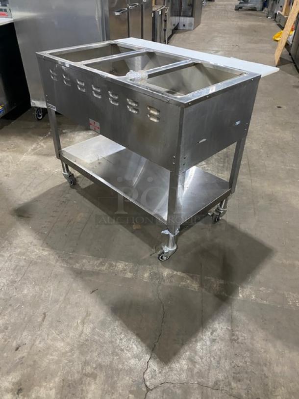 Duke AeroHot WB303 3-well stainless steel steamtable with undershelf, cutting board, on casters, model SN: 10249949.