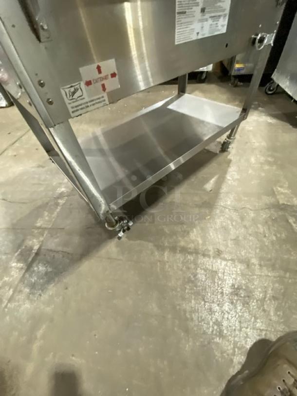 Stainless steel Duke AeroHot 3-well steamtable. Model WB303, on casters, with undershelf and cutting board. Visible labels and SN: 10249949.