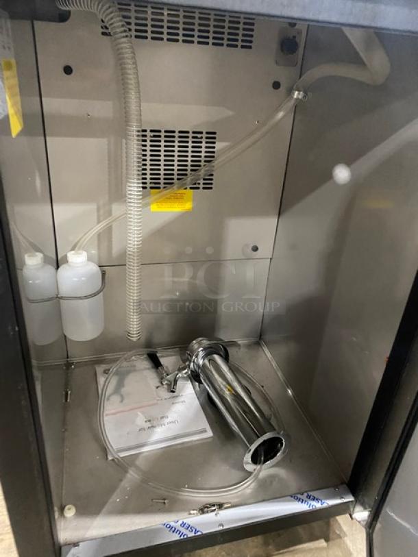 Asber 2023 ADDC23HC beer cooler interior, showing tubing, tower tap, and accessories on stainless steel worktop.