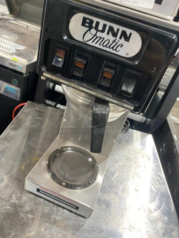 Bunn O-Matic ST-15 commercial coffee brewer, stainless steel, electric, with 2 upper warmers, model and serial labels visible.