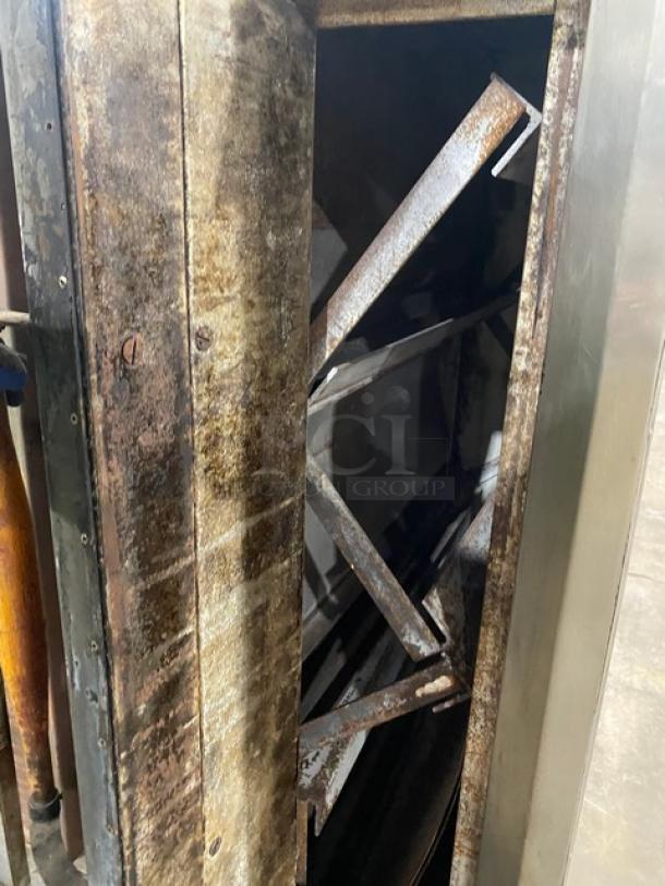 Bakers Pride commercial double-stacked pizza deck oven, natural gas powered, with legs. Visible signs of wear and rust.