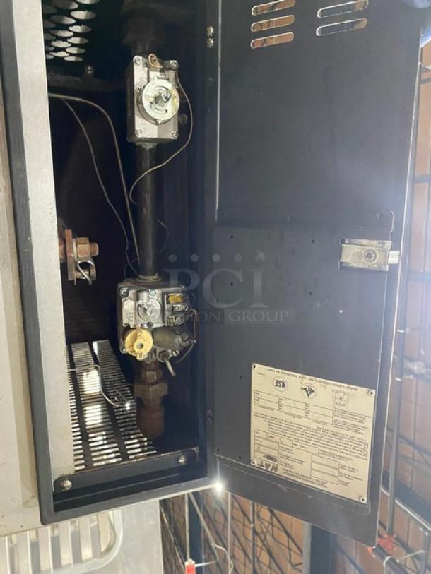 Bakers Pride commercial natural gas double-stacked pizza deck oven with legs; interior components and control panel shown.