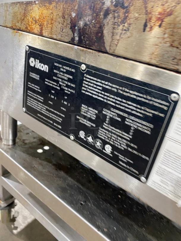 Ikon commercial stainless steel natural gas countertop char broiler with open base stand, visible label detailing model and specs.