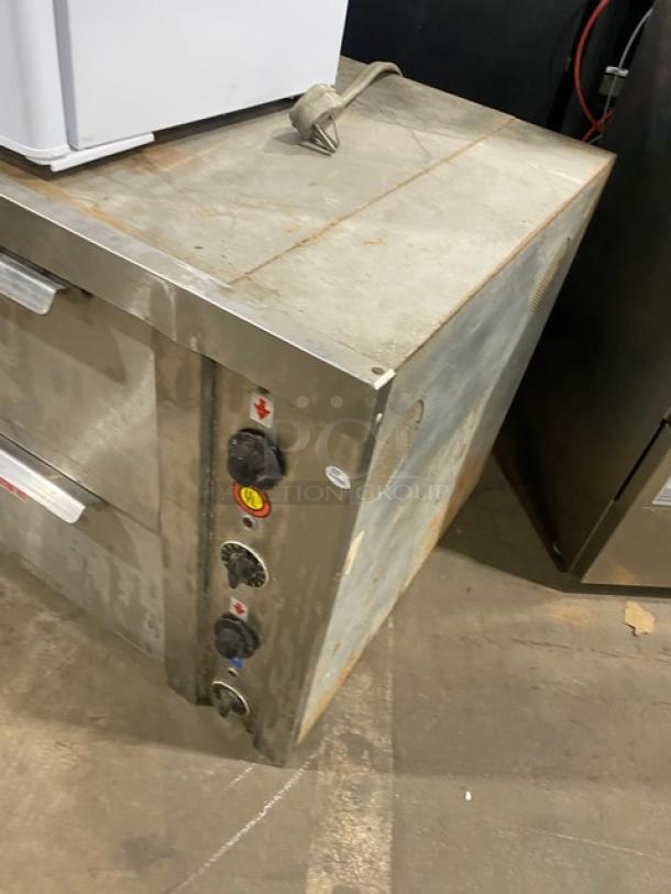 Commercial stainless steel countertop pizza oven with thermostatic controls. Electric powered. Worn condition.