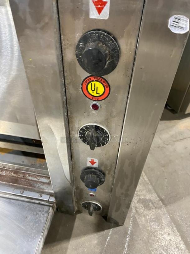 Commercial stainless steel electric countertop pizza oven with thermostatic controls, UL certification visible.