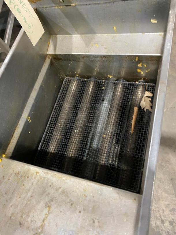 Pitco commercial stainless steel gas deep fryer, features backsplash, basket hanger, on casters, visible wear.