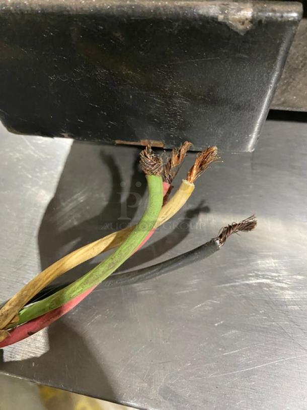 Frayed electrical wires on a Hobart HL662 commercial mixer indicate repair needed. Wiring exposed, condition poor.