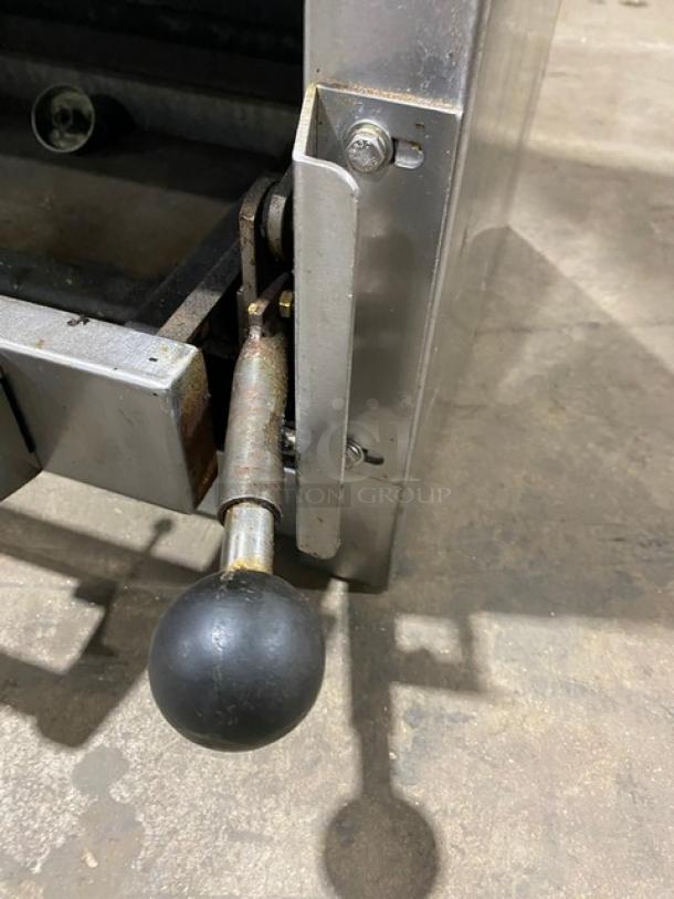 Jade Range commercial stainless steel natural gas salamander broiler handle detail, showing sturdy build and used condition.