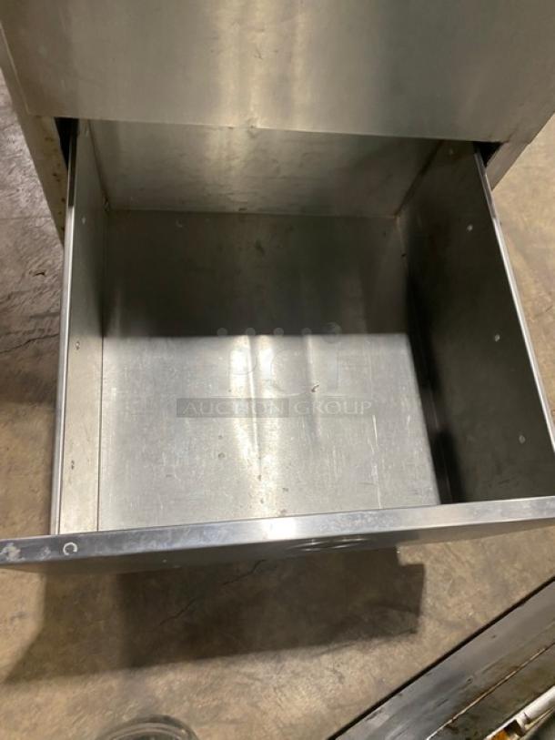 Commercial stainless steel dry storage unit with two drawers, on legs. Durable construction, suitable for kitchen use.