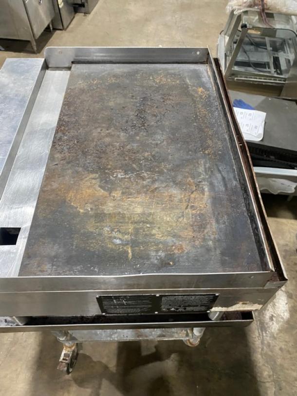 Sierra 2017 commercial stainless steel natural gas countertop flat griddle with thermostatic controls on stand with casters.