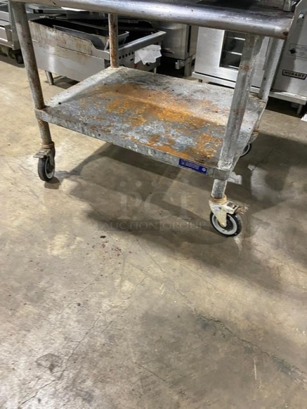 Sierra stainless steel griddle on rolling undershelf cart, visible rust and wear, thermostatic controls, natural gas powered.