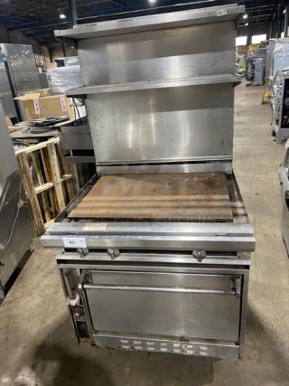 Jade Range commercial stainless steel flat top range/oven combo with backsplash, double overhead shelf, and wired oven rack.