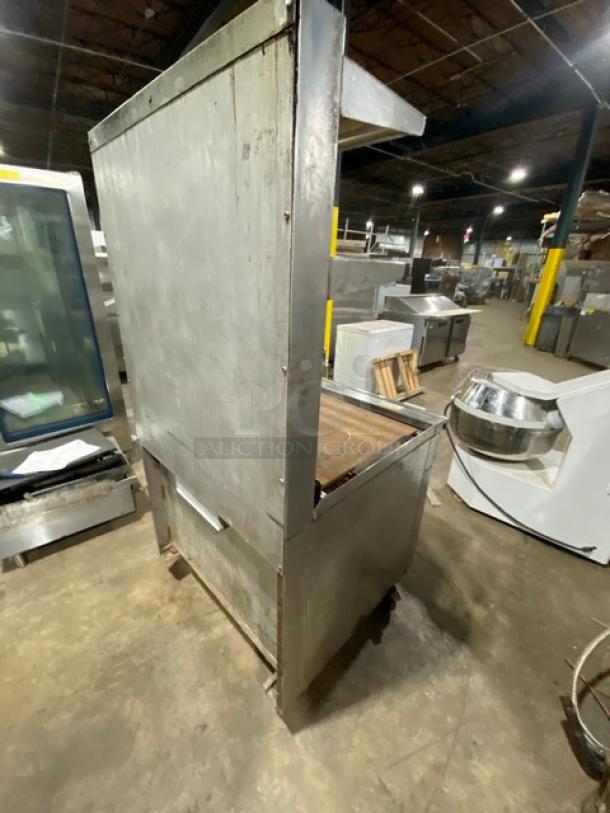 Jade Range stainless steel gas flat top range/oven combo with backsplash, double overhead shelf, and casters in used condition.