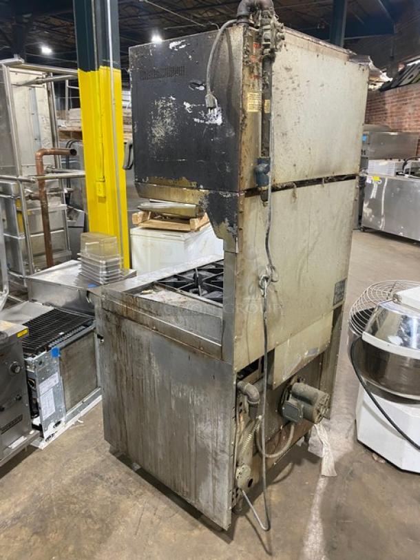 Commercial stainless steel gas-powered 4-burner griddle range with oven, backsplash, and salamander broiler. Used condition.