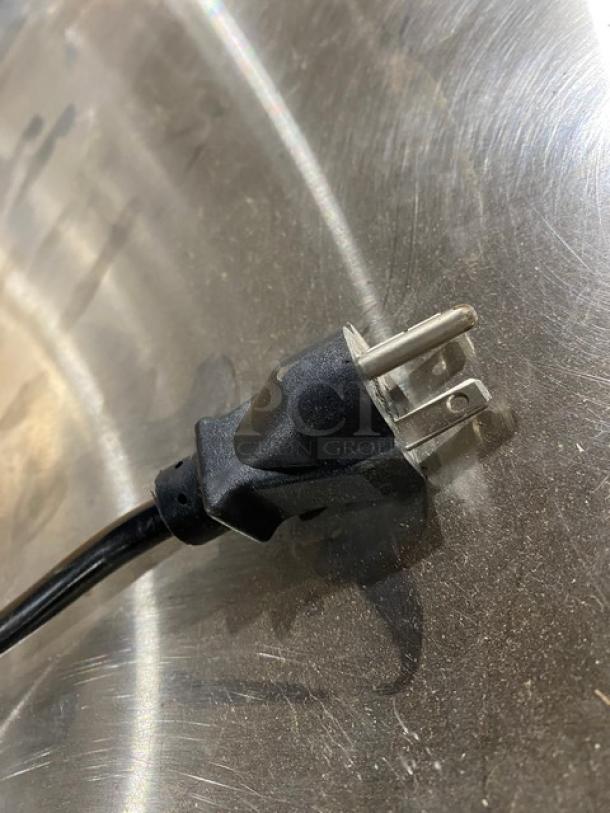 Electrical plug of Alto-Shaam Halo Heat 750-CTUS hot food holding cabinet, shown on a stainless steel surface.