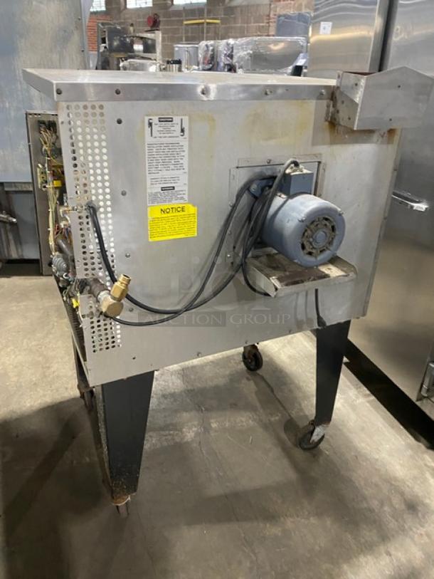 Southbend stainless steel commercial convection oven, model SLGS12SC, natural gas, with wired oven rack, on legs.