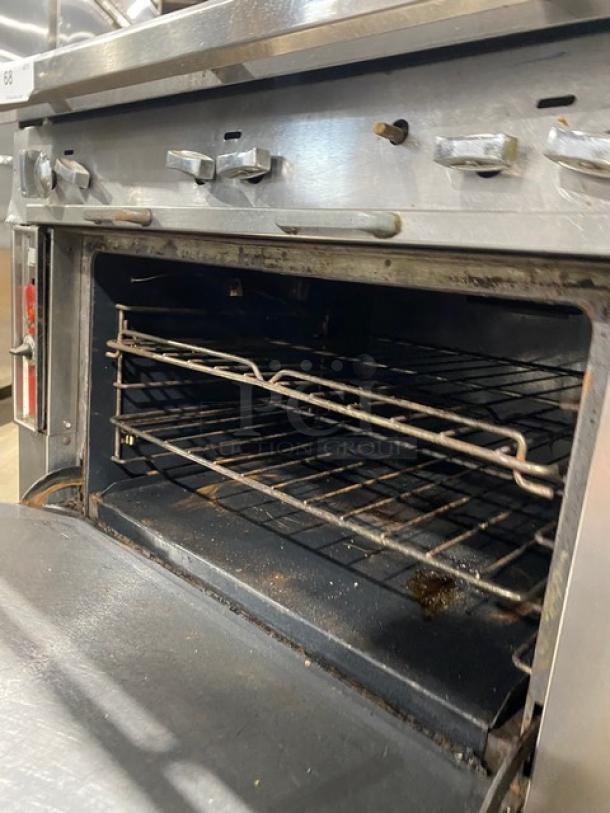 Blodgett commercial stainless steel 6-burner gas range/oven combo with backsplash, double overhead shelf, wired racks, on casters.