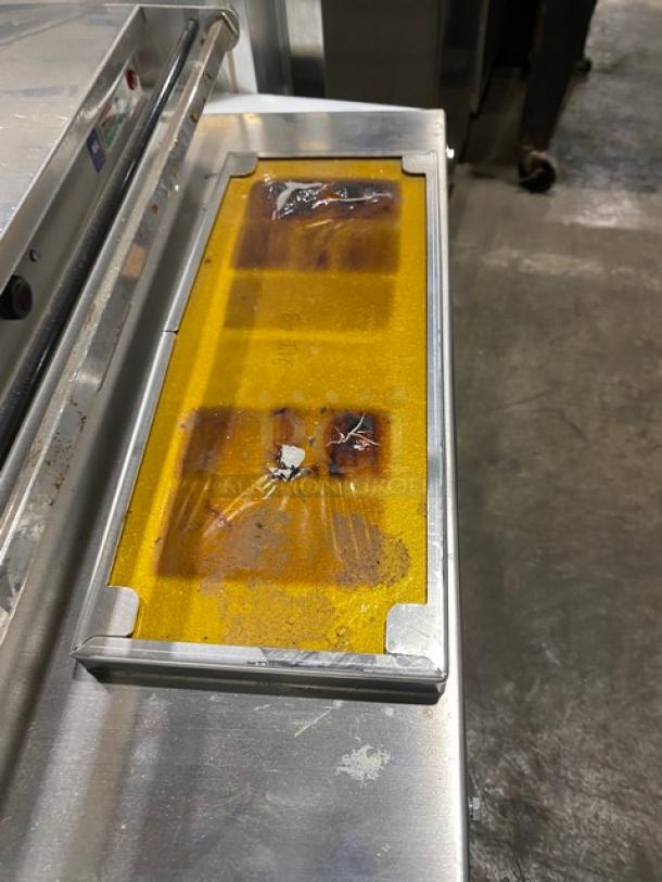 Heat Seal 700ESD stainless steel tabletop wrapper machine, electric-powered. Visible wear and stains on the surface. Model: 700ESD SN: 2110O0097. 120V.