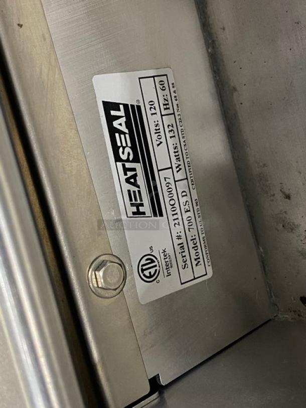 Heat Seal Model 700ESD stainless steel wrapper machine, serial 2110O0097, 120V, in good condition with visible label.