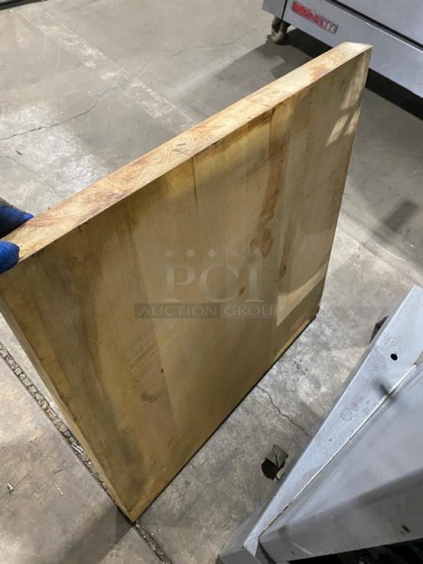 Commercial wooden chopping block style square tabletop, solid wood, used condition, visible wear on edges and surface.