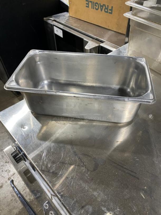 Commercial stainless steel hotel steamtable pan in good condition, showcasing a rectangular shape with visible minor wear.