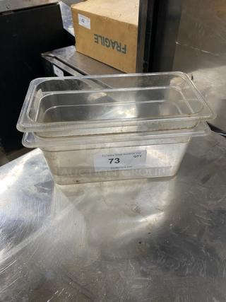 Commercial clear polycarbonate food pan, gently used. Features label "73" and auction website, sturdy and versatile.