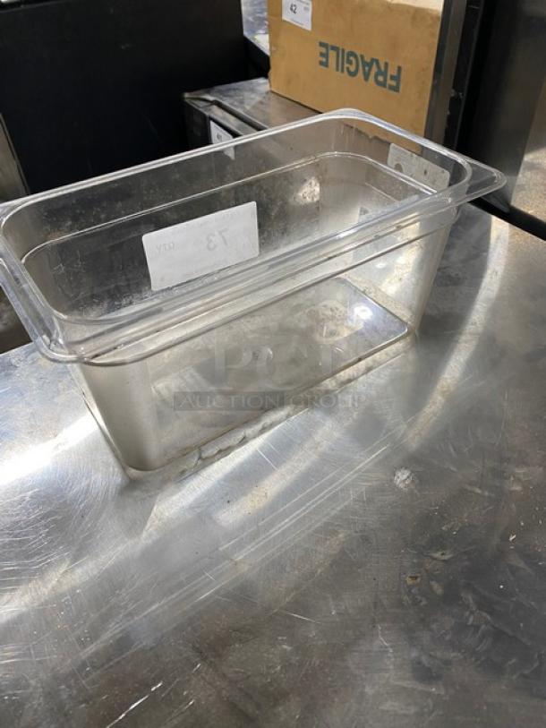 Clear polycarbonate food pan in good condition, rectangular shape, with visible capacity markings on the side.