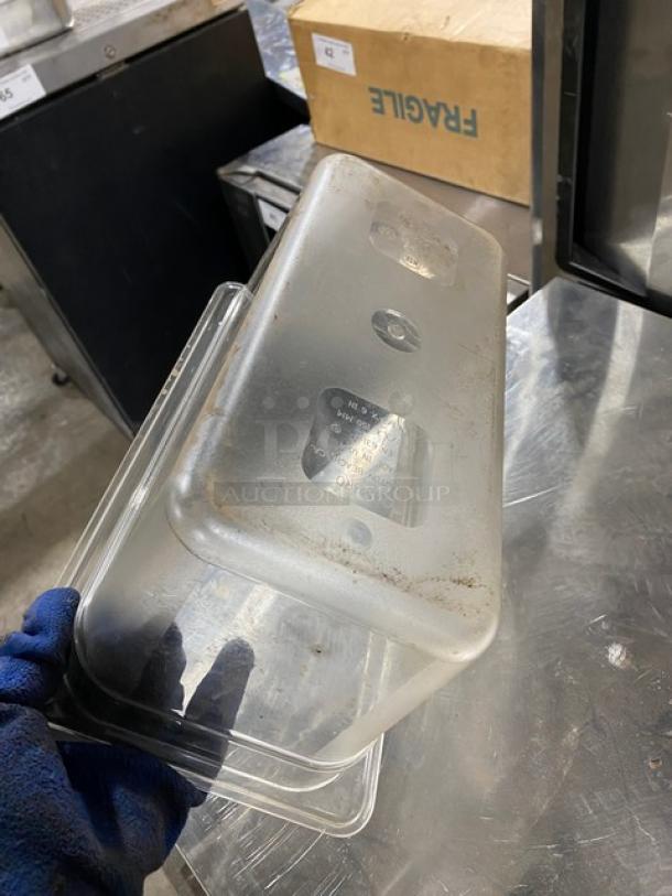 Clear polycarbonate food pan in used condition, showing surface wear. Suitable for commercial use, durable and transparent.