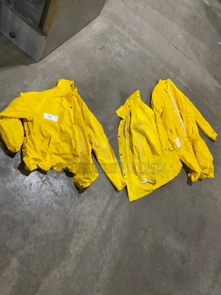 Palmer Safety RS160 Yellow PVC Raincoats, Size 2X, in good condition. Three coats shown with snap closures and high collars.
