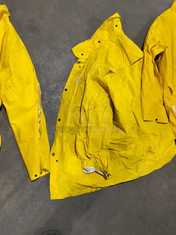 Palmer Safety RS160 yellow PVC raincoat, 2X size, in used condition with visible creases and snap closures.