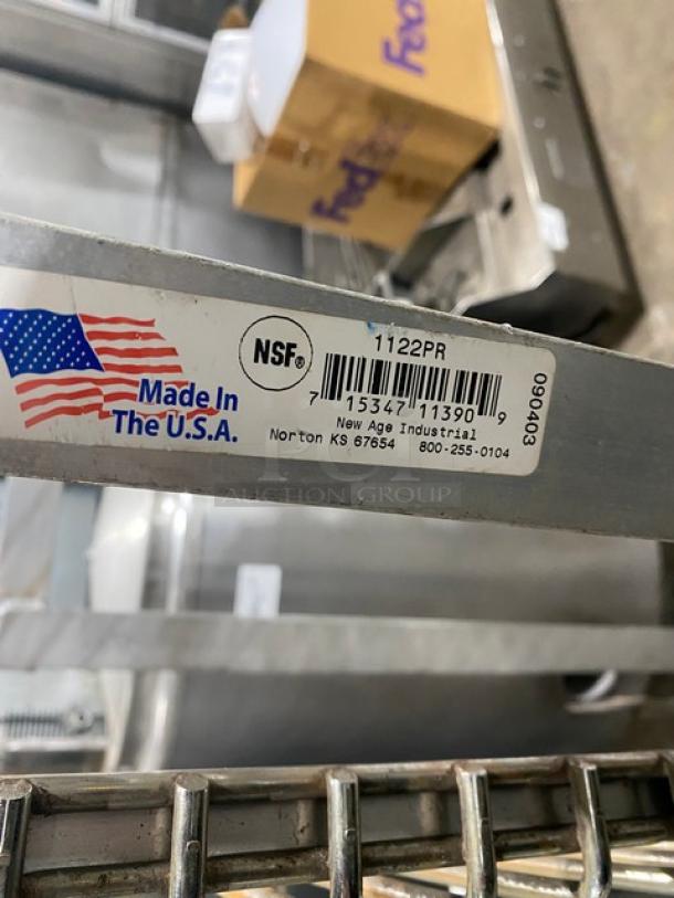 New Age Industries aluminum T-Bar wall shelf, model 1122PR. Features NSF certification and "Made in the USA" label.