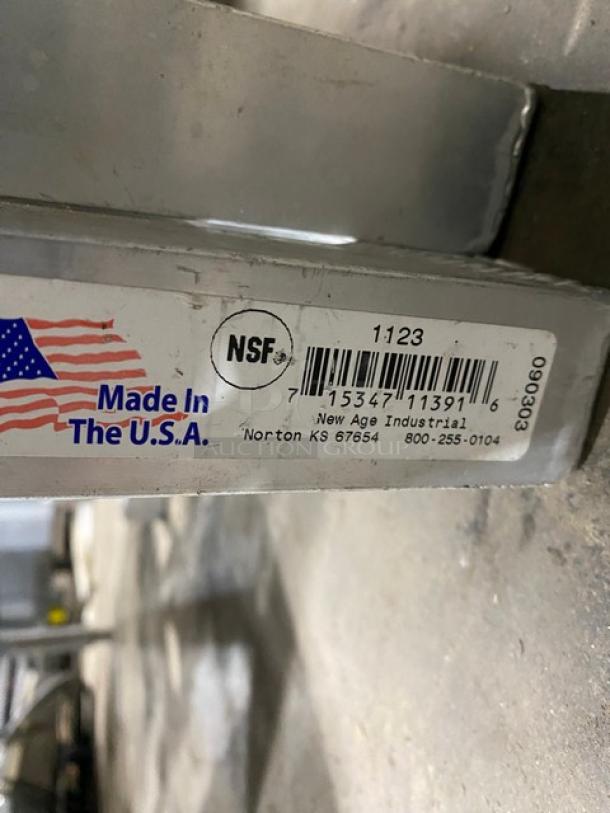 New Age Industries aluminum T-Bar wall shelf, Model 1123, NSF certified, "Made in USA" label, appears in good condition.