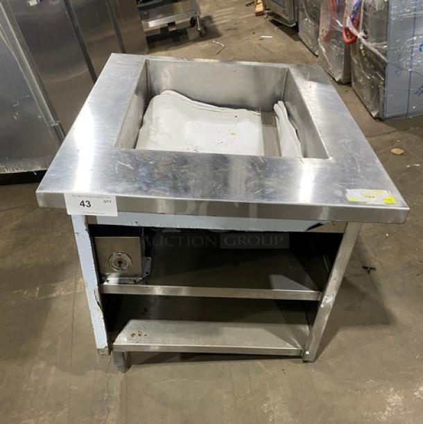 Commercial stainless steel single-well hot food/steam table with enclosed double undershelf base, on legs; shown with a dial control.