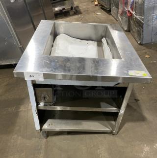 Commercial stainless steel single-well hot food/steam table with enclosed double undershelf base, on legs; shown with a dial control.