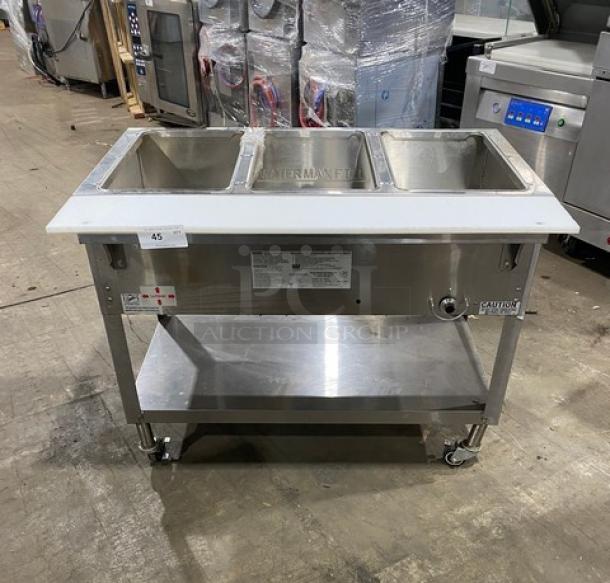 Duke Manufacturing AeroHot Series 3-Well Hot Food Steamtable, Model WB303, stainless steel, with undershelf, cutting board, on casters.
