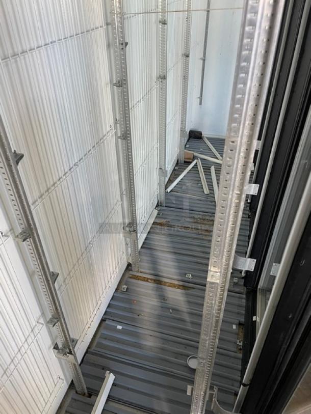 Marc Refrigeration GDL-5 commercial stainless steel merchandiser freezer interior, poly-coated wire racks, visible shelving supports.