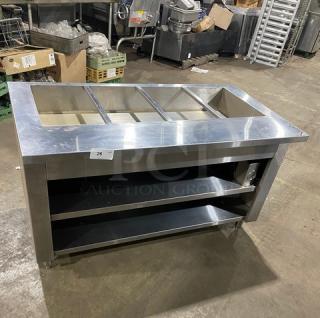 Cecilware stainless steel 4-well hot food steamtable with enclosed double shelf base. Electric powered, on legs.