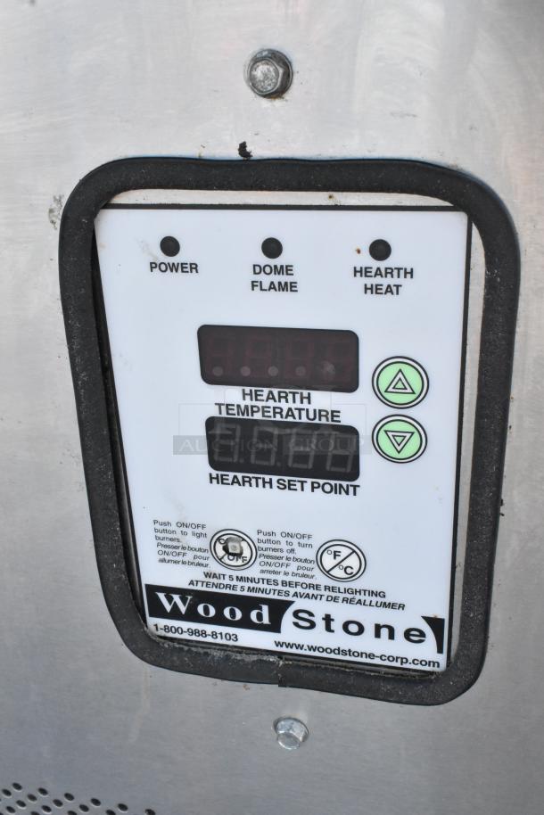Wood Stone WS-MS-6-RFG-IR-W-NG pizza oven control panel, showing power, flame, and heat indicators, temperature settings, and branding.