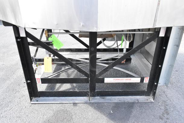 Wood Stone WS-MS-6-RFG-IR-W-NG stainless steel pizza oven base with visible safety tags and forklift instructions.