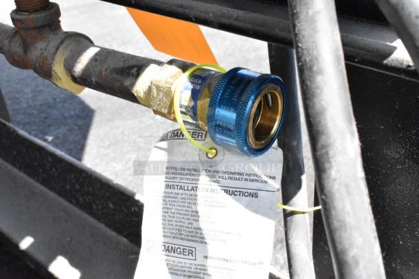 Gas connector on a Wood Stone WS-MS-6-RFG-IR-W-NG pizza oven with installation instructions tag.
