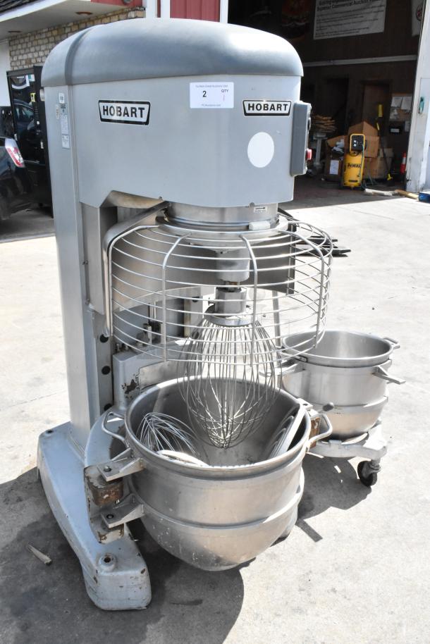 Hobart Legacy HL800 80 Quart Mixer with two stainless steel bowls, bowl dolly, bowl guard, paddles, and whisks.
