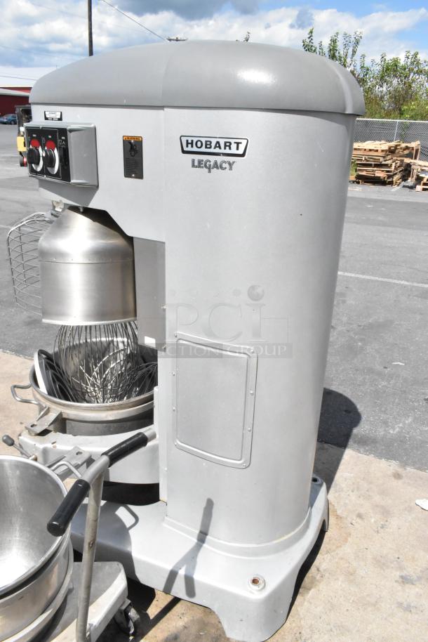 Hobart Legacy HL800 80 qt commercial dough mixer, metal body, with 2 stainless steel bowls, dolly, guard, paddles, and whisks.