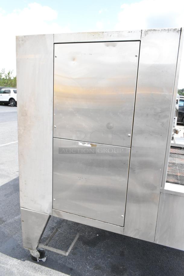 Stainless steel Wood Stone WS-SFR-6-SB commercial rotisserie with charbroiler, on casters. Visible wear on exterior.
